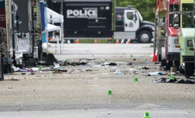 Evidence markers line 43rd Avenue in Vancouver, where a vehicle drove into crowd at a street festival on the night before, on Sunday April 27, 2025. (Rich Lam/The Canadian Press via AP)