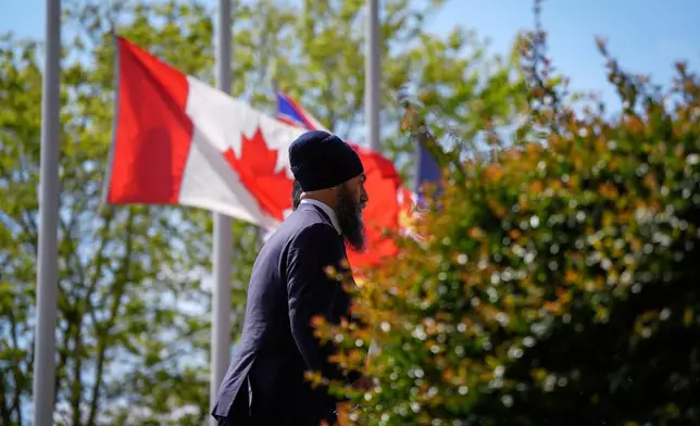 Flags are flown at half mast as NDP Leader Jagmeet Singh arrives to attend mass at St. Mary's Parish in Vancouver, British Columbia, Sunday, April 27, 2025, after multiple people that were stuck by a car on Saturday were killed at a Filipino heritage festival. (Darryl Dyck/The Canadian Press via AP)