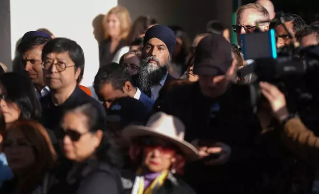NDP Leader Jagmeet Singh stands in the crowd while listening to community members speak during a vigil for the victims after a vehicle drove into a crowd Saturday and killed multiple people at a Filipino heritage festival, in Vancouver, British Columbia, Sunday, April 27, 2025. (Darryl Dyck/The Canadian Press via AP)