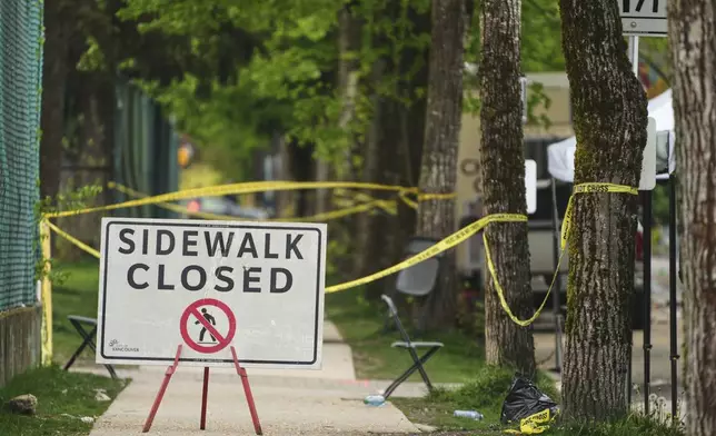 Police tape and closure signs are seen the morning after a driver killed multiple people during a Filipino community festival, Sunday, April 27, 2025, in Vancouver, British Columbia. (AP Photo/Lindsey Wasson)