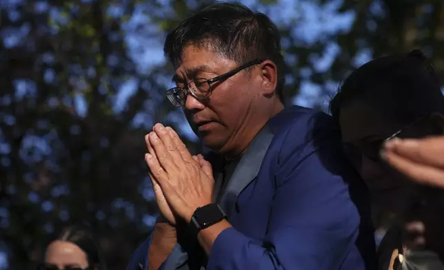 Vincent Meng prays at a vigil after a vehicle drove into a crowd during a Filipino heritage festival in Vancouver, British Columbia, Sunday, April 27, 2025. (AP Photo/Lindsey Wasson)