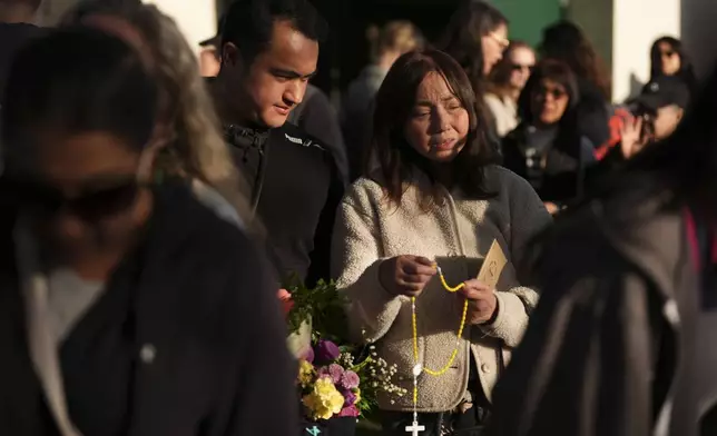 Gerard Gaba, left, and his mother Wilma Gaba, attend a vigil after a vehicle drove into a crowd during a Filipino heritage festival in Vancouver, British Columbia, Sunday, April 27, 2025. (AP Photo/Lindsey Wasson)