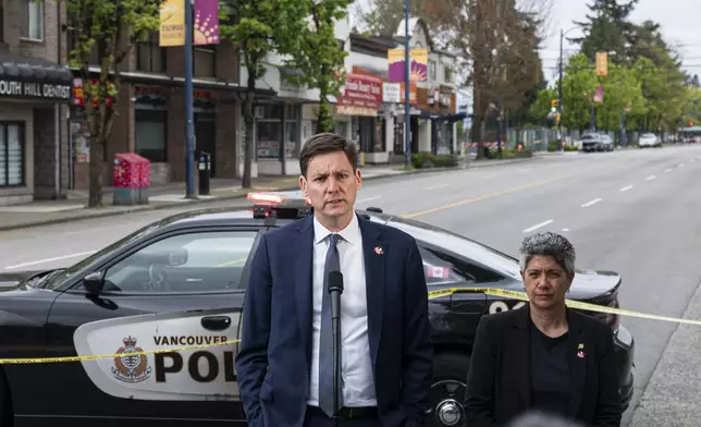British Columbia Premier David Eby, left, delivers remarks after a vehicle drove into crowd during a Lapu Lapu Day festival in Vancouver, British Columbia, Sunday, April 27, 2025. (Rich Lam/The Canadian Press via AP)
