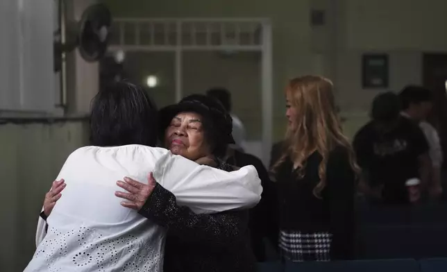Rowena Cerdena, left, hugs a fellow congregant after a worship service at the Filipino Fellowship Baptist Church in Vancouver, Canada, Sunday, April 27, 2025, the day after a driver killed multiple people at a Filipino community festival. (AP Photo/Lindsey Wasson)