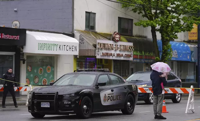 Police work the scene after a vehicle drove into a crowd during a Filipino heritage festival in Vancouver, British Columbia, Monday, April 28, 2025. (AP Photo/Lindsey Wasson)
