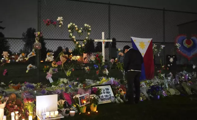 An attendee reacts at a memorial for victims after a vehicle drove into a crowd during a Filipino heritage festival in Vancouver, British Columbia, Monday, April 28, 2025. (AP Photo/Lindsey Wasson)