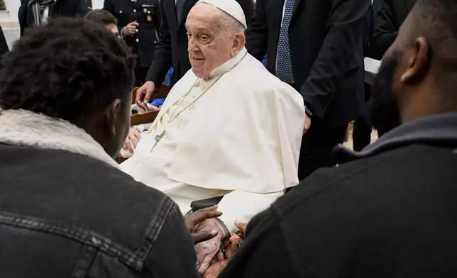Pope Francis meets with inmates during his visit to the Regina Coeli penitentiary in Rome on Holy Thursday, Thursday, April 17, 2025. (Vatican Media via AP, HO)