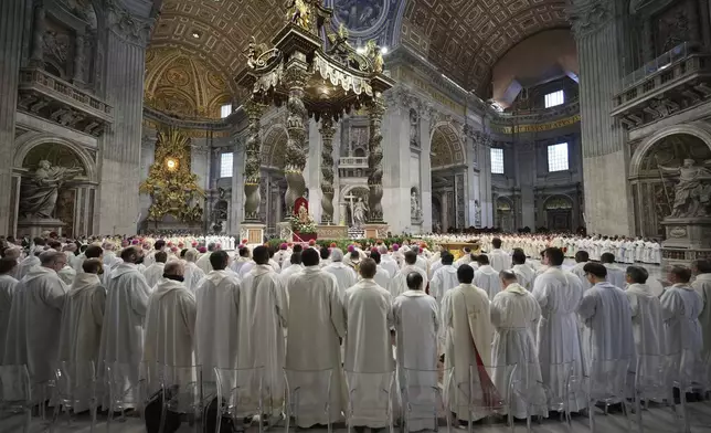 Cardinals attend the Chrism Mass presided over by Delegate of the Holy Father Cardinal Domenico Calcagno inside St. Peter's Basilica at the Vatican, Thursday, April 17, 2022. (AP Photo/Andrew Medichini)