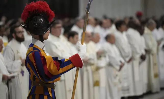 A Swiss Guard attends the Chrism Mass on Ash presided by Delegate of the Holy Father, Cardinal Domenico Calcagno at the St. Peter's Basilica at The Vatican, Thursday, April. 17, 2022. (AP Photo/Andrew Medichini)