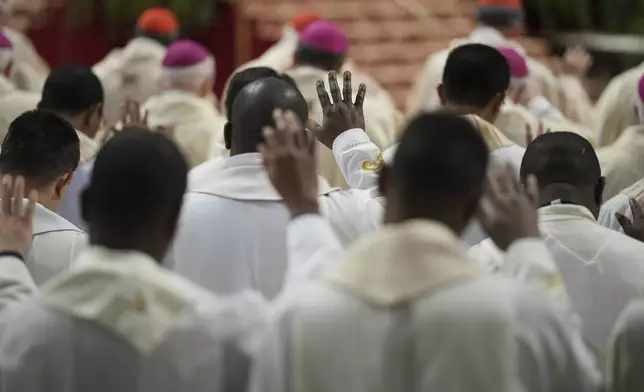 Prelates attend the Chrism Mass presided over by Delegate of the Holy Father, Cardinal Domenico Calcagno, inside St. Peter's Basilica at The Vatican, Thursday, April 17, 2022. (AP Photo/Andrew Medichini)