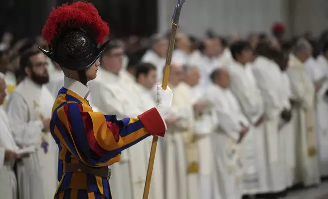A Swiss Guard attends the Chrism Mass presided over by Delegate of the Holy Father, Cardinal Domenico Calcagno, inside St. Peter's Basilica at The Vatican, Thursday, April 17, 2022. (AP Photo/Andrew Medichini)