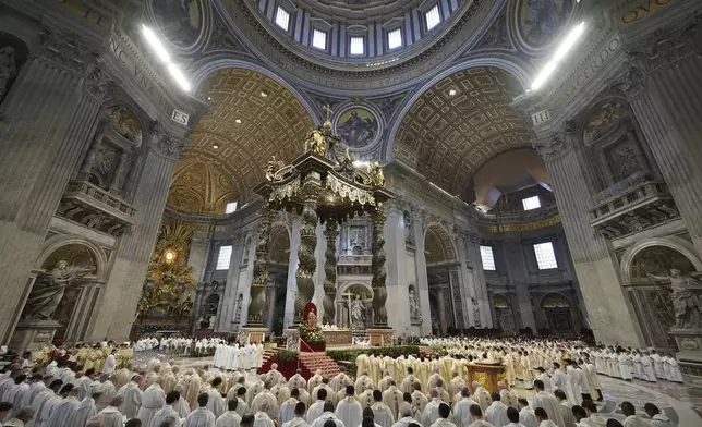 Prelates attend the Chrism Mass presided over by Delegate of the Holy Father, Cardinal Domenico Calcagno, inside St. Peter's Basilica at The Vatican, Thursday, April 17, 2022. (AP Photo/Andrew Medichini)