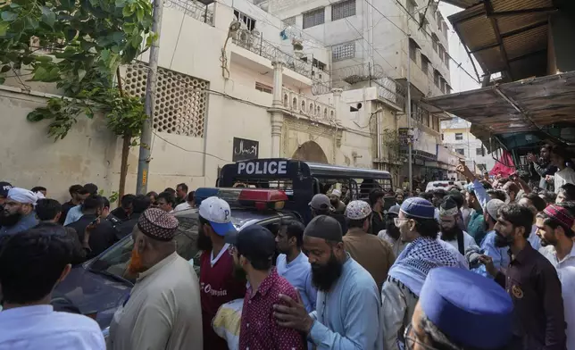 Police officers arrive to control the situation as supporters of Tehreek-e-Labbaik Pakistan or TLP party hold a demonstration against the Pakistan's minority Ahmadi community at outside their place of worship, in Karachi, Pakistan, Friday, April 18, 2025. (AP P hoto/Fareed Khan)