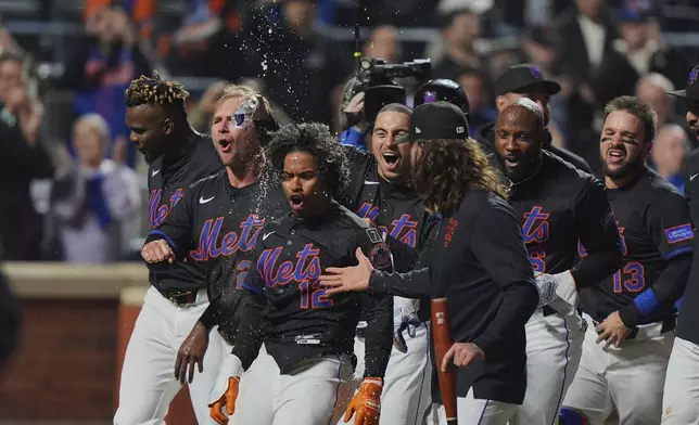 New York Mets' Francisco Lindor (12) celebrates with teammates after hitting a walk-off home run during the ninth inning of a baseball game against the St. Louis Cardinals Friday, April 18, 2025, in New York. (AP Photo/Frank Franklin II)