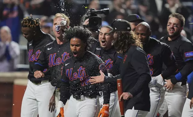 New York Mets' Francisco Lindor (12) celebrates with teammates after hitting a walk-off home run during the ninth inning of a baseball game against the St. Louis Cardinals Friday, April 18, 2025, in New York. (AP Photo/Frank Franklin II)