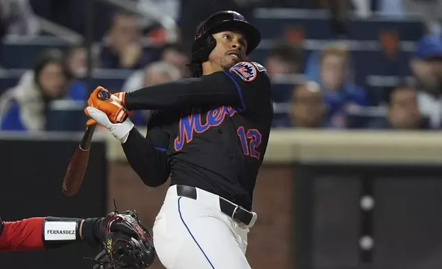 New York Mets' Francisco Lindor (12) follows through on a walk-off home run during the ninth inning of a baseball game against the St. Louis Cardinals Friday, April 18, 2025, in New York. (AP Photo/Frank Franklin II)