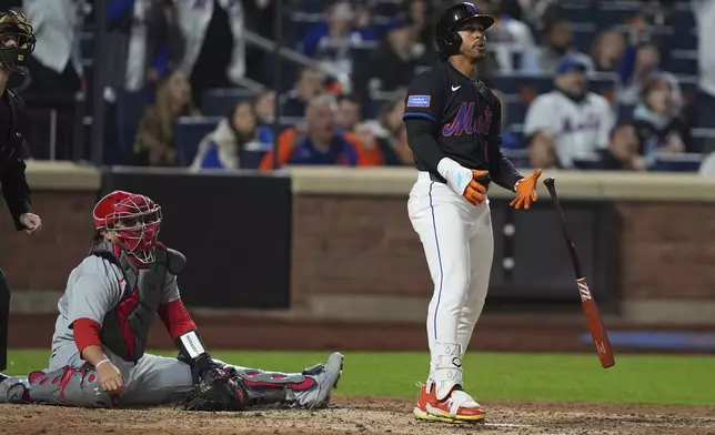 St. Louis Cardinals catcher Pedro Pagés, left, watches as New York Mets' Francisco Lindor hits a walk-off home run during the ninth inning of a baseball game Friday, April 18, 2025, in New York. (AP Photo/Frank Franklin II)