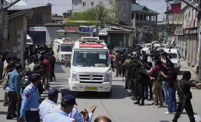 Police guard as ambulances carry bodies of tourists, in Srinagar, Indian controlled Kashmir, Wednesday, April. 23, 2025. (AP Photo/Mukhtar Khan)
