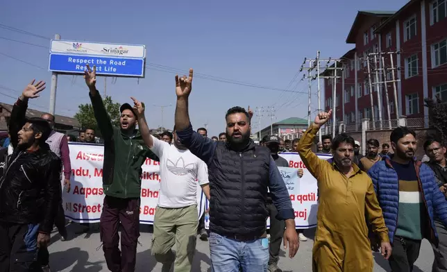 Kashmiri men shout slogans during a protest after tourists were killed in Srinagar, Indian controlled Kashmir, Wednesday, April. 23, 2025. (AP Photo/Mukhtar Khan)