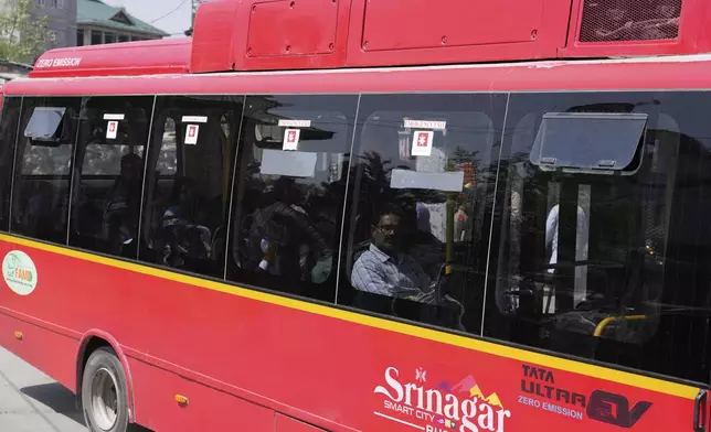 Relatives of and friends of killed tourists move in a bus towards airport in Srinagar, Indian controlled Kashmir, Wednesday, April. 23, 2025. (AP Photo/Mukhtar Khan)
