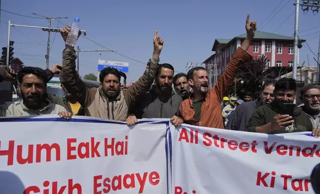Kashmiri men shout slogans during a protest after tourists were killed in Srinagar, Indian controlled Kashmir, Wednesday, April. 23, 2025. (AP Photo/Mukhtar Khan)