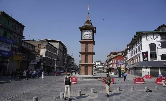 Indian policemen guard in the city centre during a shut down after tourists were killed, in Srinagar, Indian controlled Kashmir, Wednesday, April. 23, 2025. (AP Photo/Mukhtar Khan)