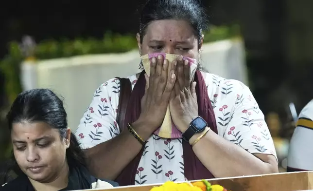 A relative of Hemant Joshi, who was a victim in a deadly attack on tourists in the Pahalgam region of Indian-administered Kashmir, reacts at Dombivali near Mumbai, India, Wednesday, April. 23, 2025.(AP Photo/Rajanish Kakade)