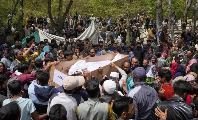 The body of Adil Hussain Shah, a daily-wage worker, who was killed when militants indiscriminately opened fire on a crowd of mainly tourists on Tuesday, is carried for burial at his village Hapatnar, about 20 km (13 miles) from Pahalgam where the incident took place, Indian controlled Kashmir, Wednesday, April 23, 2025. (AP Photo/Dar Yasin)