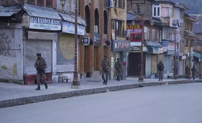 Indian security officers patrol a shopping area in Pahalgam a day after militants indiscriminately opened fire on tourists near the town, Indian controlled Kashmir, Wednesday, April 23, 2025. (AP Photo/Dar Yasin)