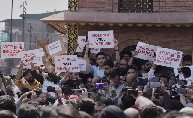 Jammu and Kashmir National Conference (JKNC) members attend a protest after tourists were killed, in Srinagar, Indian controlled Kashmir, Wednesday, April. 23, 2025. (AP Photo/Mukhtar Khan)