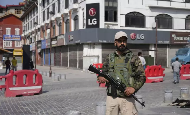 An Indian policeman guards in the city centre during a shut down after tourists were killed, in Srinagar, Indian controlled Kashmir, Wednesday, April. 23, 2025. (AP Photo/Mukhtar Khan)