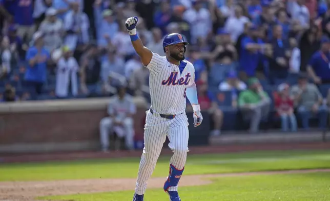 New York Mets' Starling Marte reacts after hitting a walk-off single during the tenth inning of a baseball game against the Philadelphia Phillies, Wednesday, April 23, 2025, in New York. (AP Photo/Seth Wenig)