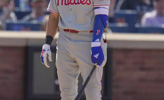 Philadelphia Phillies' Trea Turner reacts after striking out looking during the ninth inning of a baseball game against the New York Mets, Wednesday, April 23, 2025, in New York. (AP Photo/Seth Wenig)