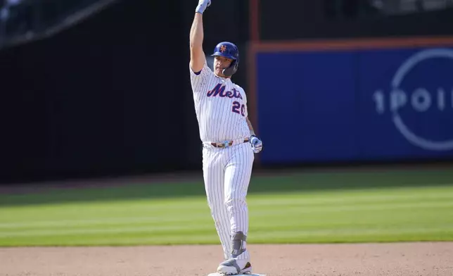 New York Mets' Pete Alonso reacts after hitting an RBI double during the tenth inning of a baseball game against the Philadelphia Phillies, Wednesday, April 23, 2025, in New York. (AP Photo/Seth Wenig)