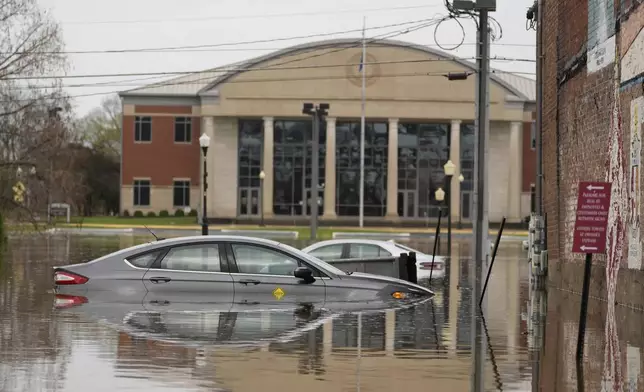 Cars sit in a flooded street in Hopkinsville, Ky., Friday, April 4, 2025. (AP Photo/George Walker IV)