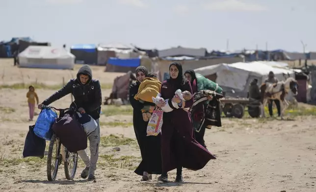 FILE – Displaced Palestinians fleeing Rafah amid ongoing Israeli military operations arrive in Khan Younis, in the southern Gaza Strip, Sunday, March 23, 2025. (AP Photo/Abdel Kareem Hana, File)