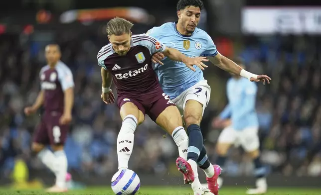 Manchester City's Omar Marmoush, right, challenges for the ball with Aston Villa's Matty Cash during the English Premier League soccer match between Manchester City and Aston Villa at Etihad stadium in Manchester, England, Tuesday, April 22, 2025. (AP Photo/Jon Super)