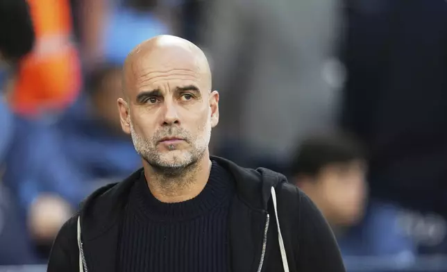 Manchester City's head coach Pep Guardiola waits for the start of the English Premier League soccer match between Manchester City and Aston Villa at Etihad stadium in Manchester, England, Tuesday, April 22, 2025. (AP Photo/Jon Super)