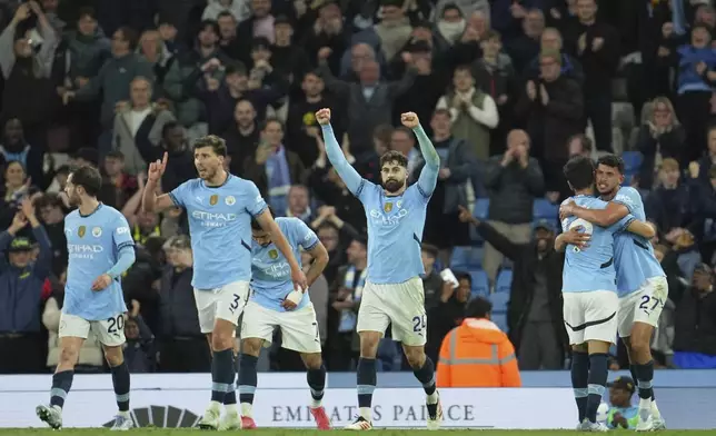 Manchester City players celebrate their victory at the English Premier League soccer match between Manchester City and Aston Villa at Etihad stadium in Manchester, England, Tuesday, April 22, 2025. (AP Photo/Jon Super)