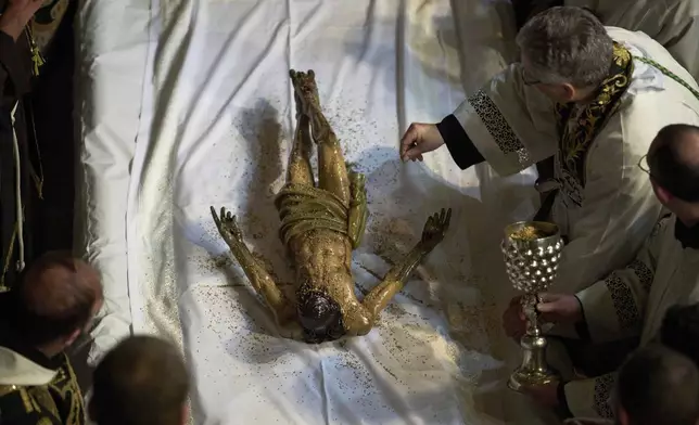 Catholic clergymen take part in a Holy Week ceremony reenacting the funeral of Jesus Christ at the Church of the Holy Sepulcher, the site where according to tradition Jesus was crucified and buried, in the Old City of Jerusalem on Friday, April 18, 2025. (AP Photo/Leo Correa)