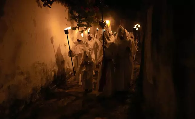 Penitents take part in the Procession of Souls during Holy Week in Goias, Brazil, Thursday, April 17, 2025. (AP Photo/Eraldo Peres)