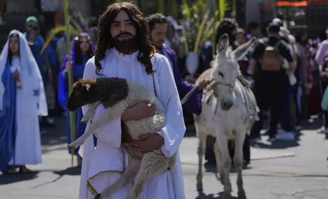 Claudio Armando Ramirez plays the role of Jesus Christ during a Palm Sunday Passion Play at the San Lucas de Iztapalapa parish in Mexico City, Sunday, April 13, 2025. (AP Photo/Marco Ugarte)