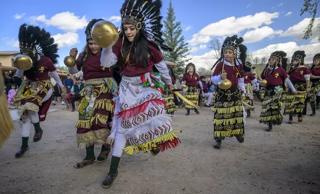 Members of the Danza Señor San Jose dance group perform behind El Santuario De Chimayo in Northern New Mexico during Holy Week on Good Friday, Chimayo, N.M., April 18, 2025. (AP Photo/Roberto E. Rosales)