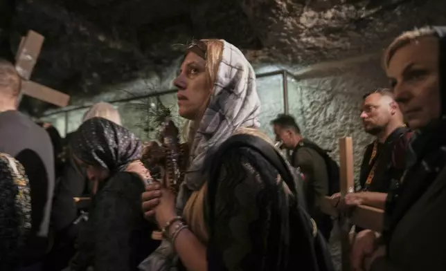 Christian pilgrims carry crosses during a Holy Week procession at the Old City of Jerusalem on Good Friday, April 18, 2025. (AP Photo/Maya Alleruzzo)