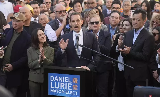 FILE - Daniel Lurie, middle, speaks at a news conference next to his wife, Becca Prowda, middle left, in San Francisco, Friday, Nov. 8, 2024. (AP Photo/Jeff Chiu, File)