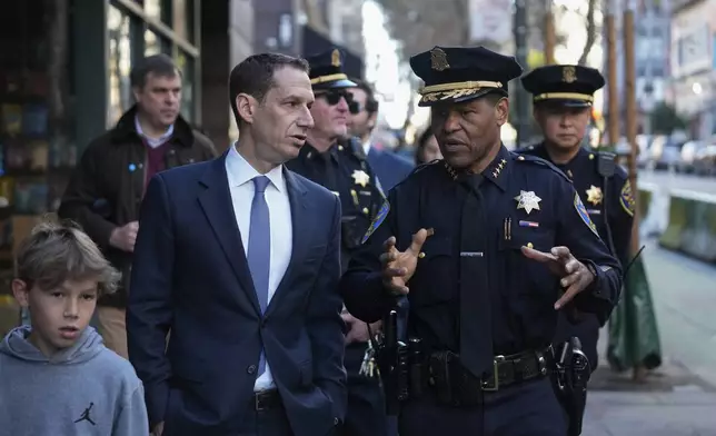 FILE - Mayor-elect Daniel Lurie, left, speaks to San Francisco Police Chief William Scott while walking through the Tenderloin neighborhood Wednesday, Jan. 8, 2025, in San Francisco. (AP Photo/Godofredo A. Vásquez, File)