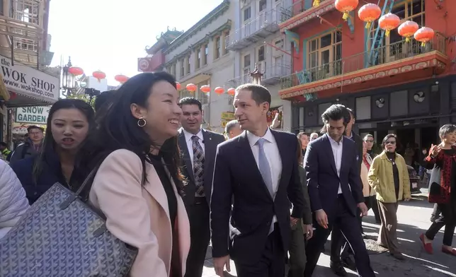 FILE - San Francisco mayoral candidate Daniel Lurie, middle, tours businesses as he walks through Chinatown in San Francisco, Friday, Nov. 8, 2024. (AP Photo/Jeff Chiu, File)