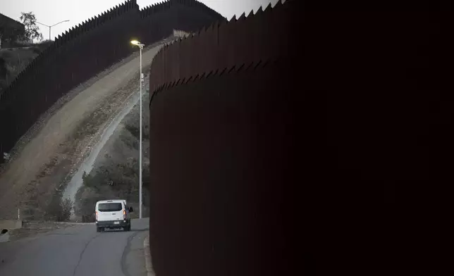 FILE— A Border Patrol van transports a group of migrants, Jan. 21, 2025, after they crossed illegally between two border walls separating Mexico and the United States in San Diego, Texas. (AP Photo/Gregory Bull, File)