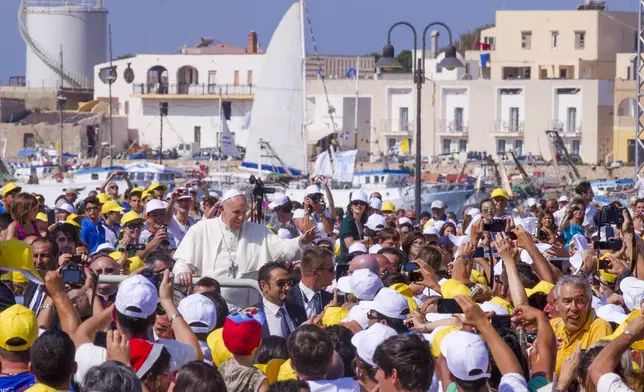 FILE - Pope Francis waves to a cheering crowd during his visit to the island of Lampedusa, Sicily, in southern Italy, July 8, 2013. (AP Photo/Alessandra Tarantino, File)
