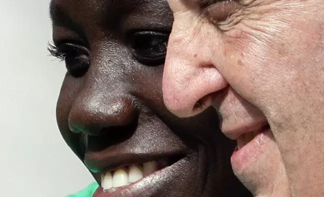 FILE - Pope Francis poses for a selfie photo with a migrant during his weekly general audience at the Vatican, Sept. 27, 2017. (AP Photo/Andrew Medichini, File)